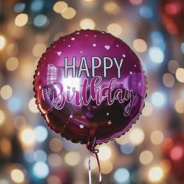 Pink birthday balloon with white lettering and heart dots