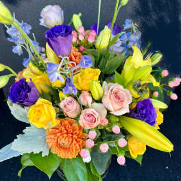 Colorful mixed bouquet with roses, lilies, and dahlias