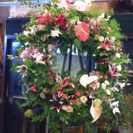 Large floral wreath with lilies, anthuriums, and roses
