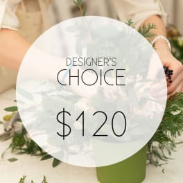 Designer's choice floral arrangement in a green container