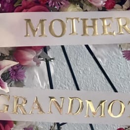Floral wreath with satin ribbons reading Mother and Grandmother