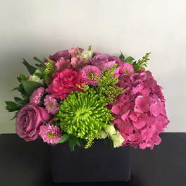 Pink and purple bouquet with a bright green chrysanthemum in a black box