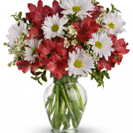 Red and white mixed bouquet in a clear glass vase