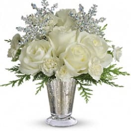 White rose bouquet in a silver vase with silver filler and greenery