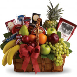 Fruit and snack gift basket with a pineapple, bananas, grapes, apples, and cheese boxes