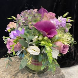 Bouquet of purple and pink flowers in a glass vase