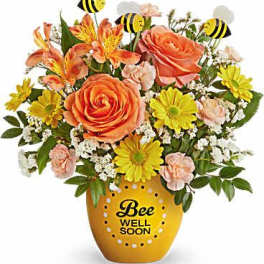 Orange and yellow flower arrangement in a bee-themed pot with bee picks