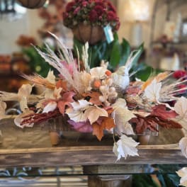 Autumn centerpiece with dried leaves and grasses in a low tray