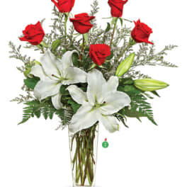 Tall glass vase arrangement with red roses and white lilies