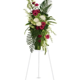 Tall floral standing spray with pink and white blooms on an easel