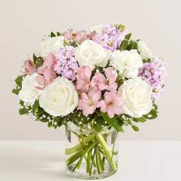 Pink and white bouquet in a clear glass vase