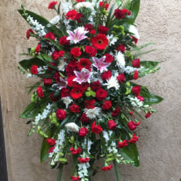 Large standing floral spray with red, white, and pink blooms