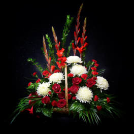 Red and white floral arrangement in a basket with tall stems