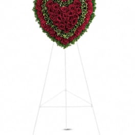 Heart-shaped floral standing spray with red roses and green accents