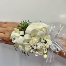 White floral wrist corsage with ribbon and tulle