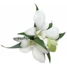 White orchid corsage with green leaves and ribbon