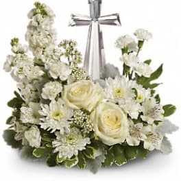 White floral cross arrangement with a silver ribbon