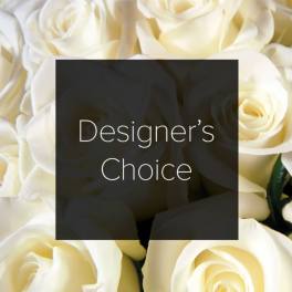 Cream-colored roses with a "Designer’s Choice" label overlay