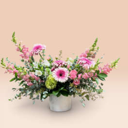 Pink and white mixed flower arrangement in a white vase