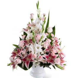 Pink and white mixed bouquet in a white pedestal vase