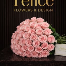 Large bouquet of pale pink roses on a dark surface