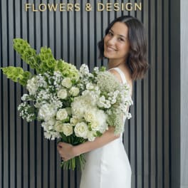 Bride holding a large white and green bouquet