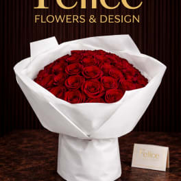 Bouquet of red roses wrapped in white paper