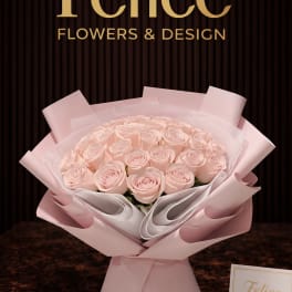 Bouquet of pale pink roses wrapped in pink paper