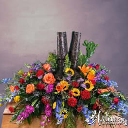 Colorful floral arrangement around a pair of black boots