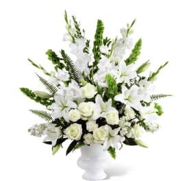 White floral arrangement in a white pedestal vase