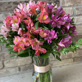 Bouquet of pink and purple alstroemeria in a glass vase