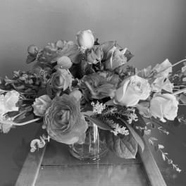 Large mixed flower arrangement in a clear glass vase