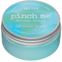 A turquoise tin labeled "pinch me" therapy dough