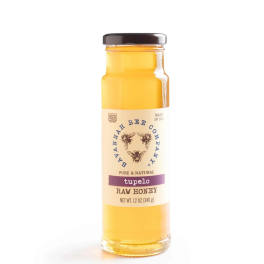Jar of tupelo raw honey with a dark lid