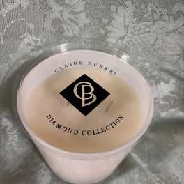 Pink candle in a clear plastic cup with a labeled lid