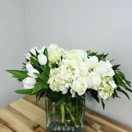 White floral arrangement in a clear glass vase