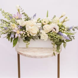 Long pastel floral arrangement in a white rectangular box
