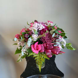 Pink and purple mixed bouquet in a clear glass vase
