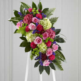 Pink and purple floral spray on a white easel