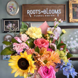 Colorful mixed bouquet with sunflowers, roses, and pastel blooms