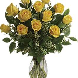Yellow roses arranged in a clear glass vase