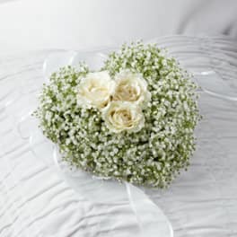 White rose bouquet with baby's breath and a sheer ribbon