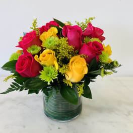 Bouquet of red and yellow roses in a glass vase