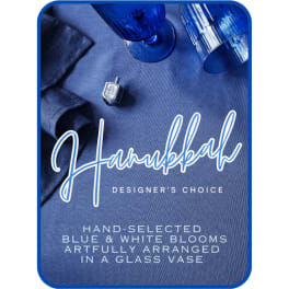 Blue and white blooms arranged in a glass vase on a blue background