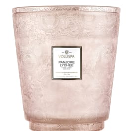 Pink patterned candle in a decorative glass vessel