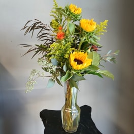 Sunflower arrangement in a clear glass vase