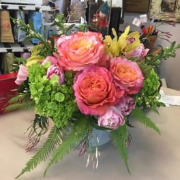 Pink and peach rose bouquet with green hydrangea in a vase