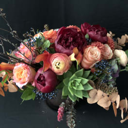 Mixed bouquet with pink and burgundy flowers and a green succulent