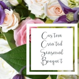 Bouquet of pink, white, and purple flowers with a text card