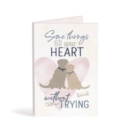Greeting card with two dogs and the text "Something fill your HEART without TRYING"
